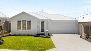 A single-story house with a front yard, a garage, and a small porch.