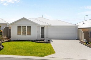 A single-story house with a front yard, a garage, and a small porch.