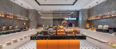 A modern breakfast buffet with a central island, shelves with food items, and a clean, contemporary design.