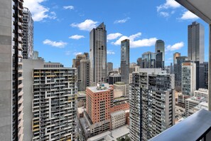 A high-rise urban area with multiple buildings, including a prominent red building and several modern skyscrapers. - High-Rise 1-Bed Apartment Near Southern Cross (Melbourne)