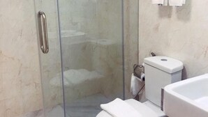 A bathroom with a glass-enclosed shower, a toilet, and a sink. - Taragrand Donmuang Airport Hotel (Thanyaburi)