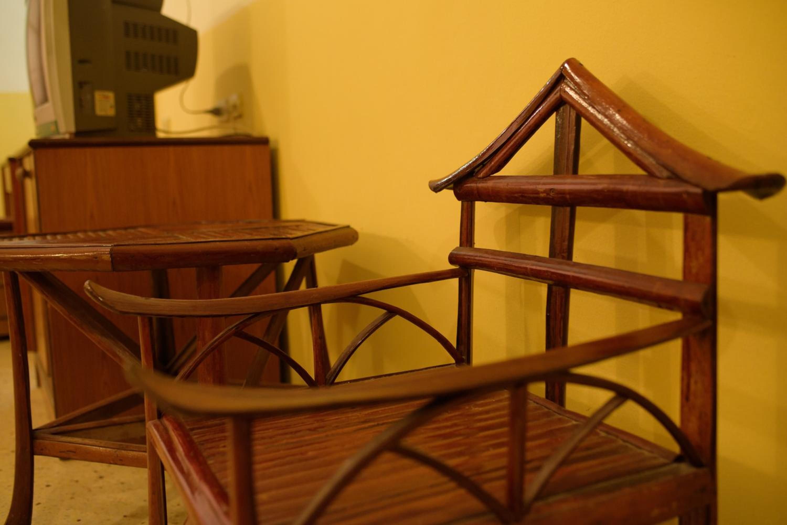 A wooden chair with a curved backrest and a table with a round top.