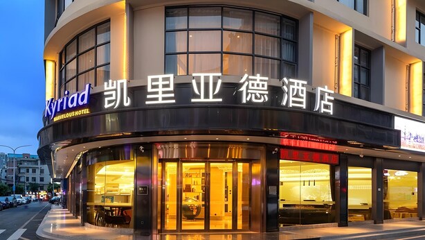 A hotel with a curved facade, large windows, and a sign in both English and Chinese. - Kyriad Marvelous Hotel Shenzhen Nanlian Metro Station (Shenzhen)