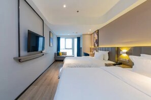 A hotel room with two beds, a flat-screen TV mounted on the wall, a bedside table with a lamp, and a window with curtains. - 7 Days Premium Hotel (Chongqing)