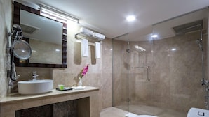 A modern bathroom with a glass-enclosed shower, a sink with a mirror, and a toilet. - Grand Palace Rangpur (Rangpur)