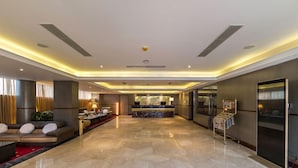 A spacious lobby with a reception desk, seating area, and a modern design. - Grand Palace Rangpur (Rangpur)