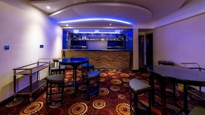 A bar area with a counter, stools, and a patterned carpet. - Grand Palace Rangpur (Rangpur)