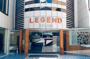 A hotel entrance with a modern design, featuring a prominent sign that reads 'LEGEND KALAM.'