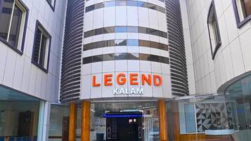 A modern building with a curved facade and the name 'LEGEND KALAM' prominently displayed.