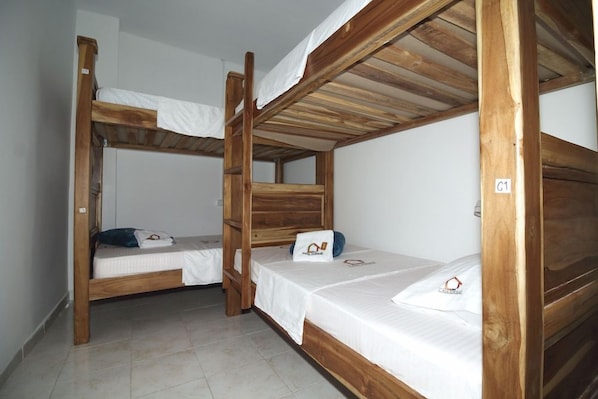 A room with three bunk beds, each with a white mattress and pillow. - Hostal Casa Torres Centro Historico Adults Only (Cartagena)