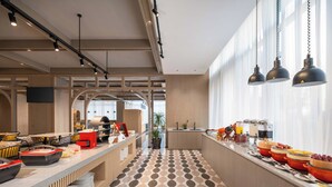 Un café moderno con una barra alargada, varias zonas de estar y un suelo estampado.