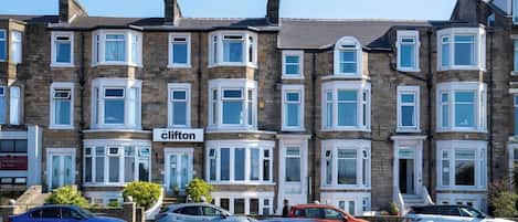 A row of terraced houses with a sign reading 'Clifton'.