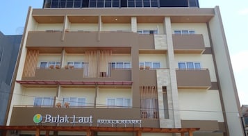 Un hotel de varios pisos con balcones y un letrero que indica que es un hotel y resort.