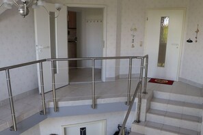 A staircase with a metal handrail leading to an upper floor. - Holiday apartment in Süsel with swimming pool (Süsel)