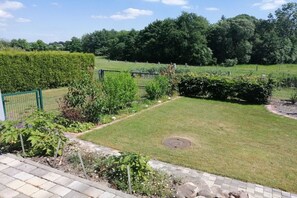 A well-maintained garden with a variety of plants and a neatly trimmed lawn. - Holiday apartment in Süsel with swimming pool (Süsel)