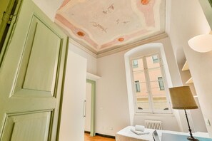 A room with a green door, a window with shutters, a radiator, and a lamp. - [Corte House] 5Terre-Near the station (La Spezia)