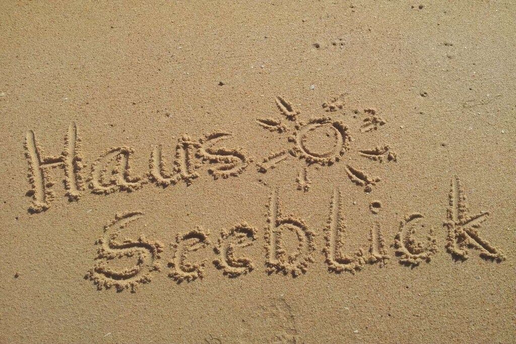 Sand with the words 'Haws Seeblick' and a sun symbol.