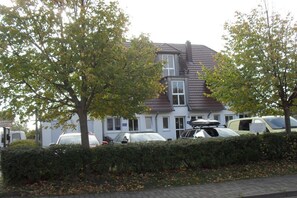 A residential building with a two-story structure, a pitched roof, and a visible garage. - Holiday home with 2 bedrooms (Breege-Juliusruh)