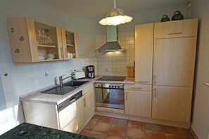 A compact kitchen with a sink, stove, and cabinets. - Holiday home in Prerow with barbecue (Prerow)