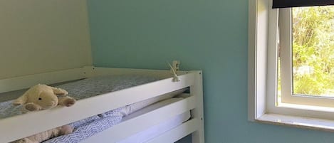 A bunk bed with a window on the right side.