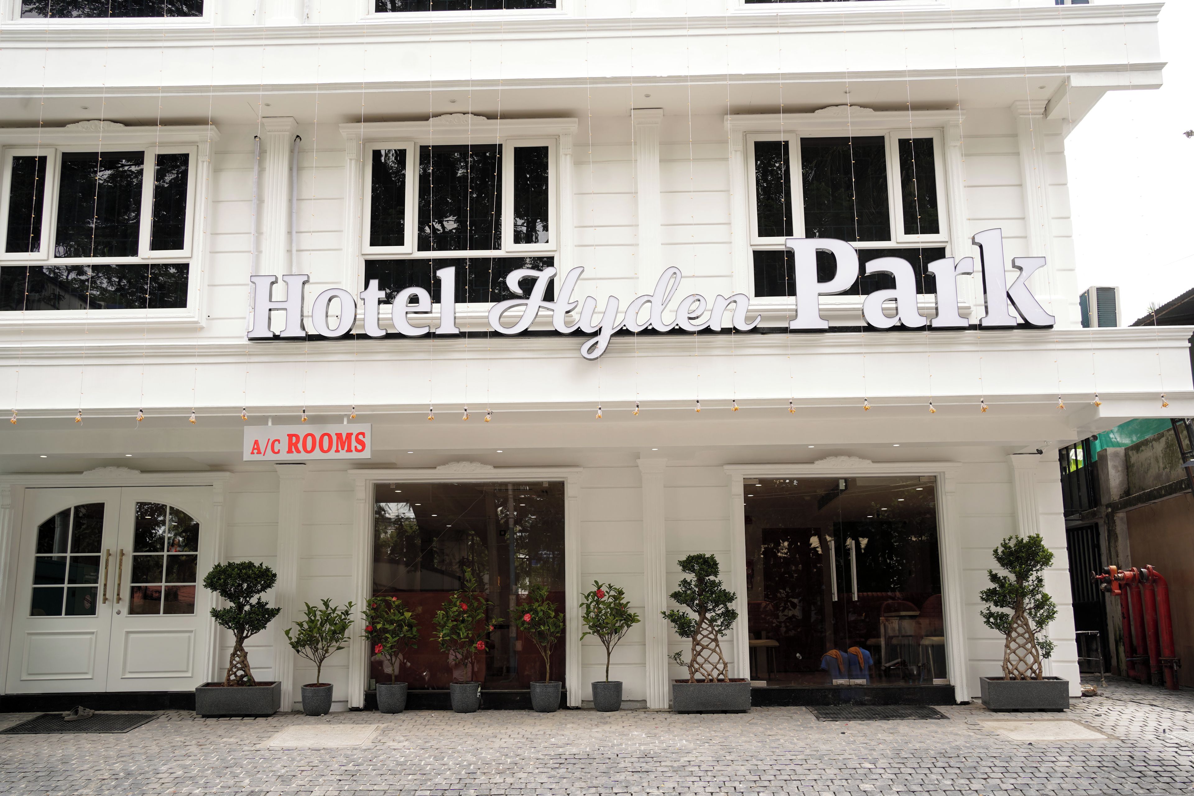A hotel facade with a sign reading 'Hotel Aydin Park' and a sign for 'A/C Rooms' indicating air-conditioned accommodations.