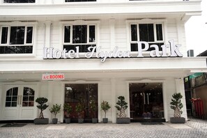 A hotel facade with a sign reading 'Hotel Aydin Park' and a sign for 'A/C Rooms' indicating air-conditioned accommodations.
