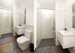 A modern bathroom with a glass shower enclosure, a toilet, and a sink. - The Lennox Suite by HDG (Accra)
