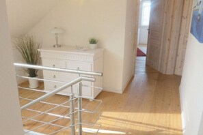 A room with a white dresser, a metal rack, and a potted plant. - Holiday home in Niesgrau with swimming pool (Niesgrau)