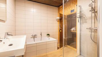 A modern bathroom with a bathtub, a glass-enclosed shower, and a wooden vanity.