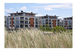 A multi-story residential building with balconies and large windows. - Holiday apartment with 1 bedroom (Heiligenhafen)