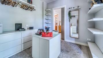 A modern bathroom with a vanity, mirror, and towel rack.