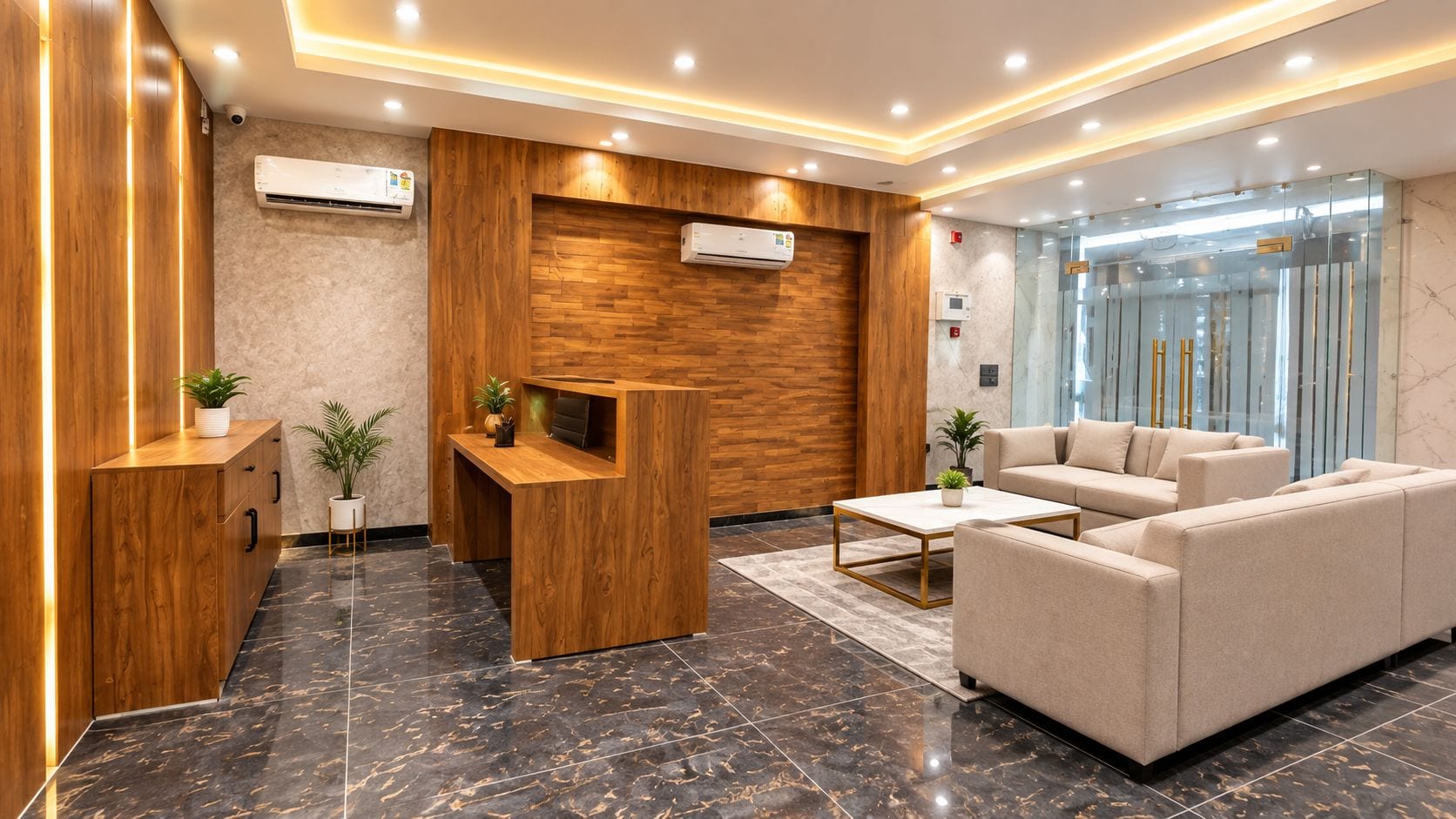 A modern reception area with a wooden reception desk, seating area, and glass partition.