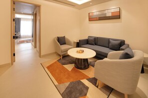 A modern living room with a sofa, armchairs, a coffee table, and a rug. - Keys Prima by Lemon Tree Hotels, Nashik (Nashik)