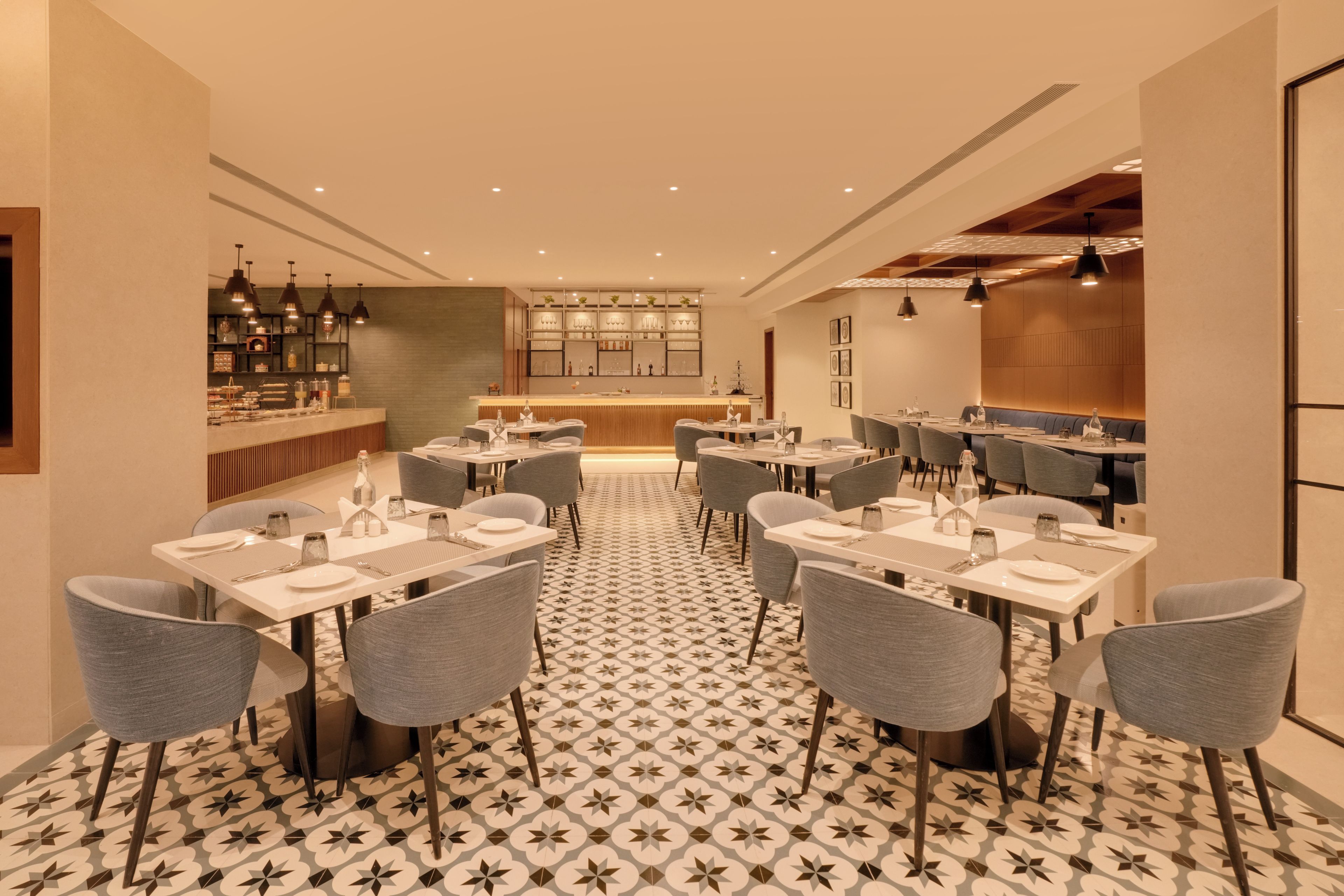 A restaurant with multiple tables, chairs, and a bar area.