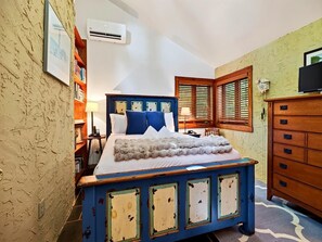 A bedroom with a bed, a dresser, a bookshelf, and a window with shutters. - Merryland with Wintergreen Advantage (Wintergreen)