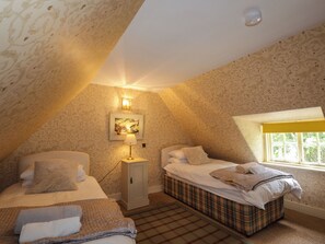 A bedroom with two beds, a window, and a painting on the wall. - Middle Lodge (Rogart)