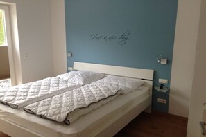 Ein Schlafzimmer mit einem Bett, einer Wandleuchte und einer Wanddekoration.