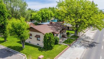 A residential property with a two-story house, a well-maintained lawn, and a driveway.