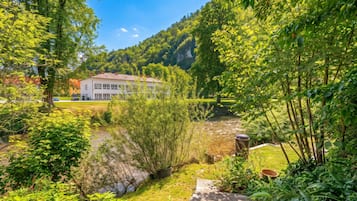 A house with a garden and a river.