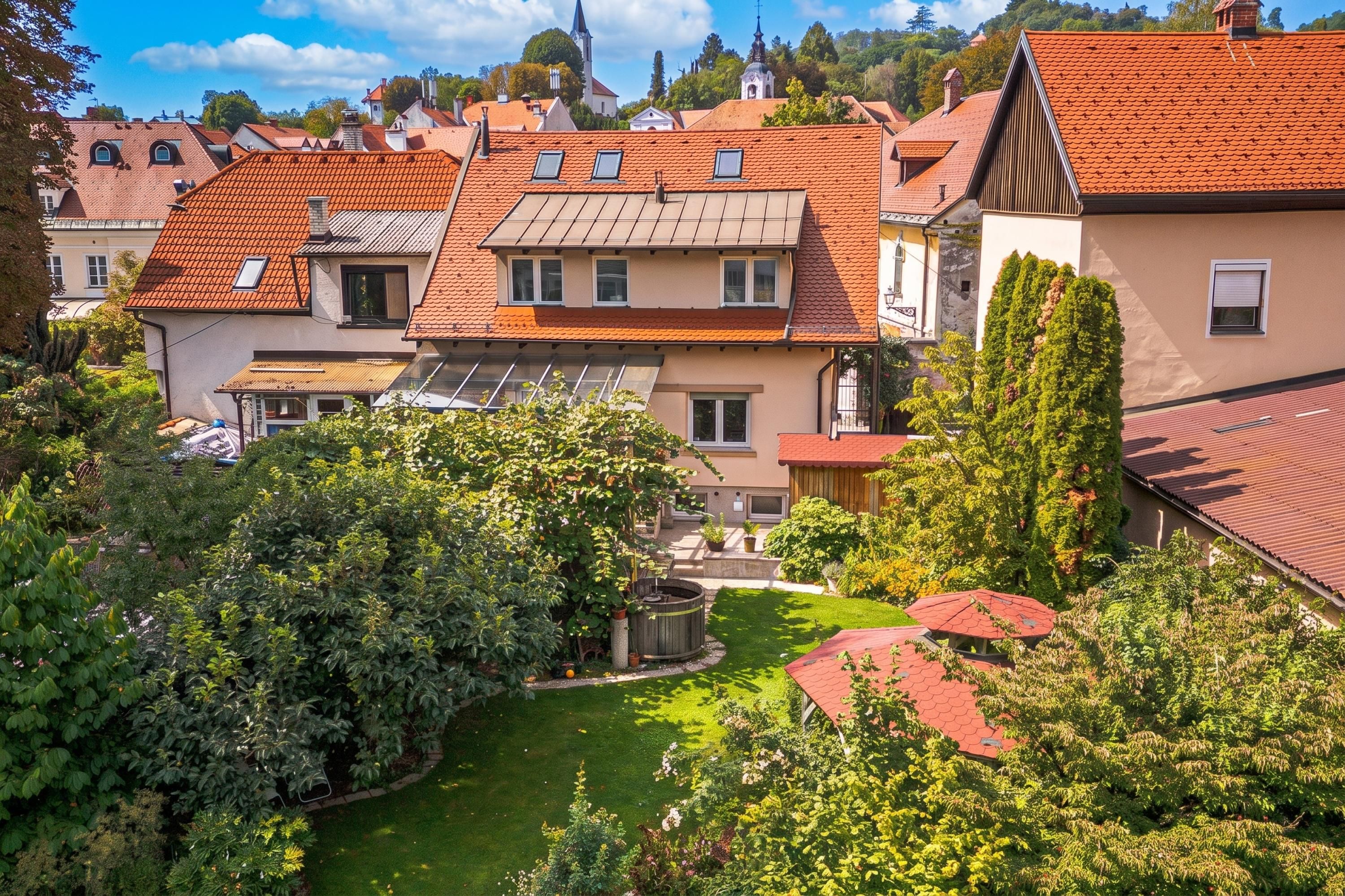 A residential area with multiple houses, a well-maintained garden, and a visible church steeple in the background.