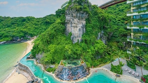 A resort with a swimming pool, a beach, and a cliffside. - Cat Ba Sea & Sand Resort (Cat Hai)