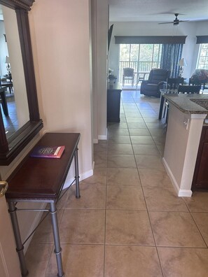 A kitchen with a dining area, a ceiling fan, and a view to the living room. - 5203 Spacious 2/2 Resort Condo Near Disney (Orlando)