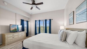 A bedroom with a bed, a dresser, a television, and a ceiling fan. - 1507 Spacious 3/2 Resort Condo Near Disney (Orlando)