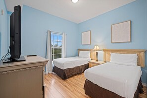A hotel room with two beds, a desk, a television, and a window. - 3502 Spacious 3/2 Resort Condo Near Disney (Orlando)