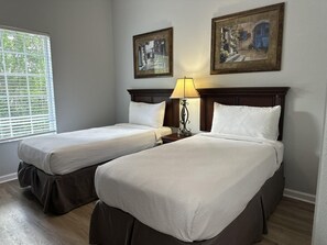 A hotel room with two beds, a window with blinds, and two framed pictures on the wall. - 4201 Spacious 3/2 Resort Condo Near Disney (Orlando)