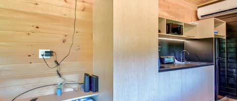 A modern kitchen with a built-in microwave, toaster, and sink.