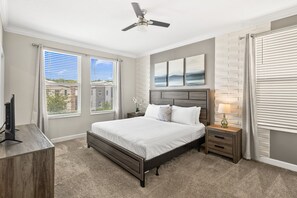 A bedroom with a bed, nightstands, a ceiling fan, and a window with blinds. - 2779 Oxymoron Way (Kissimmee)