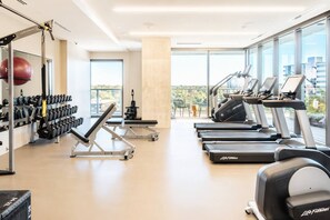 A gym with treadmills, weight machines, and a rowing machine. - Luxury 1BR Natiivo Condo with Lake View and Rooftop Heated Pool near Rainey St (Austin)