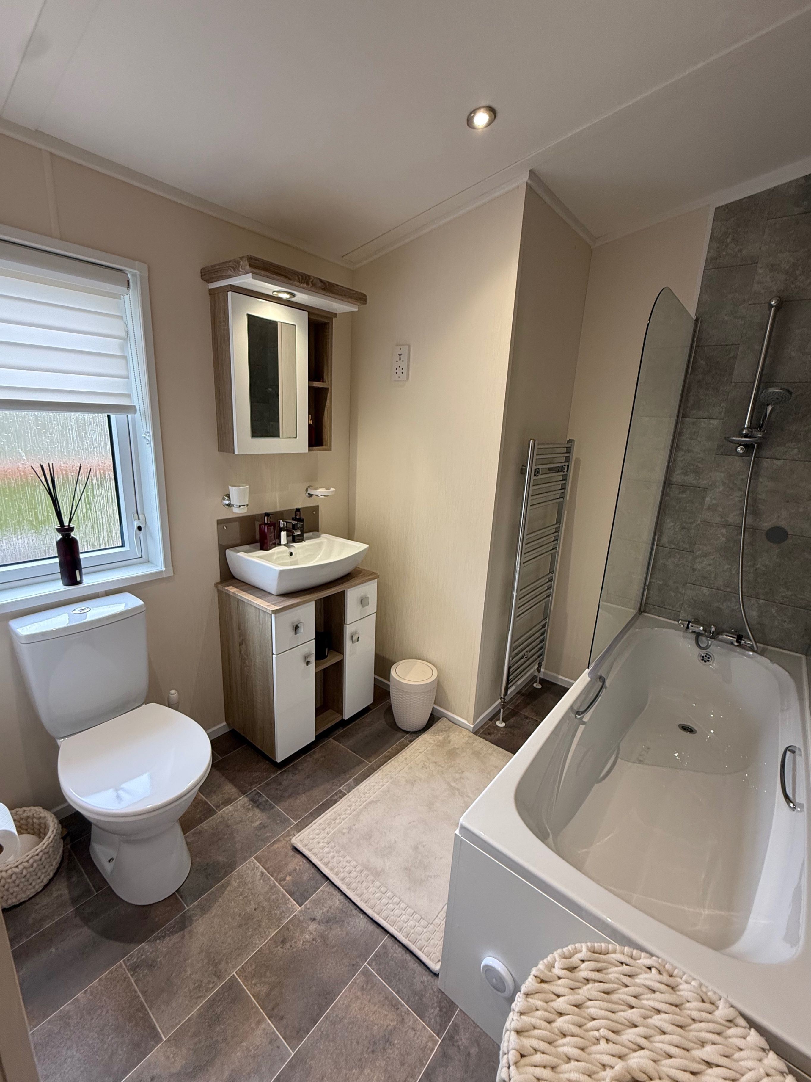 A modern bathroom with a toilet, sink, and bathtub.