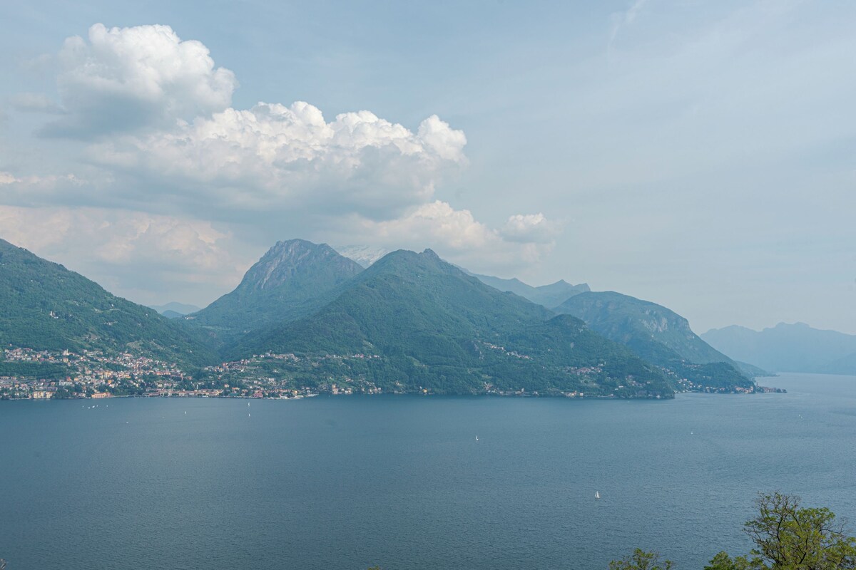 A coastal landscape with mountains and a body of water.
